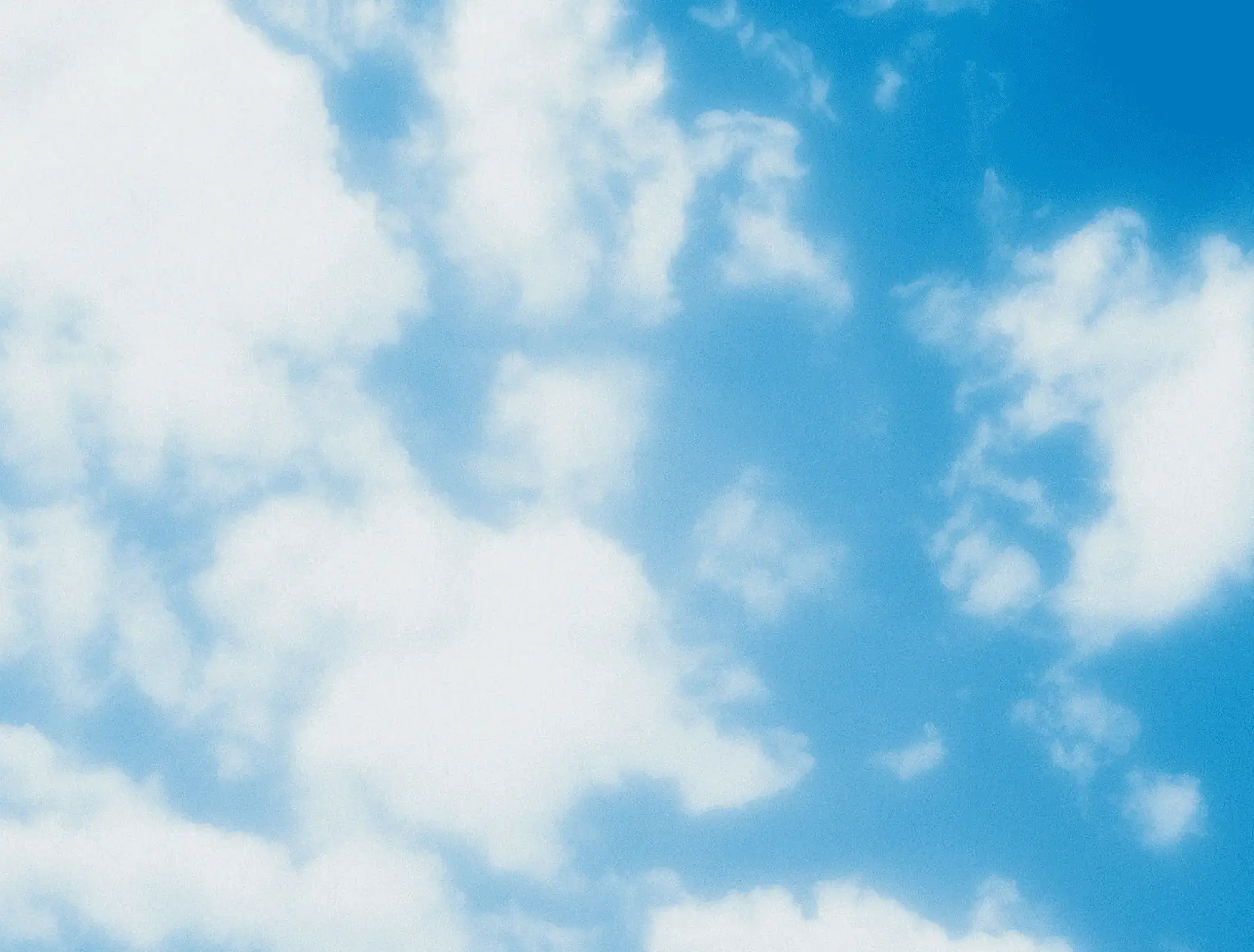 Soft white clouds floating across a light blue sky